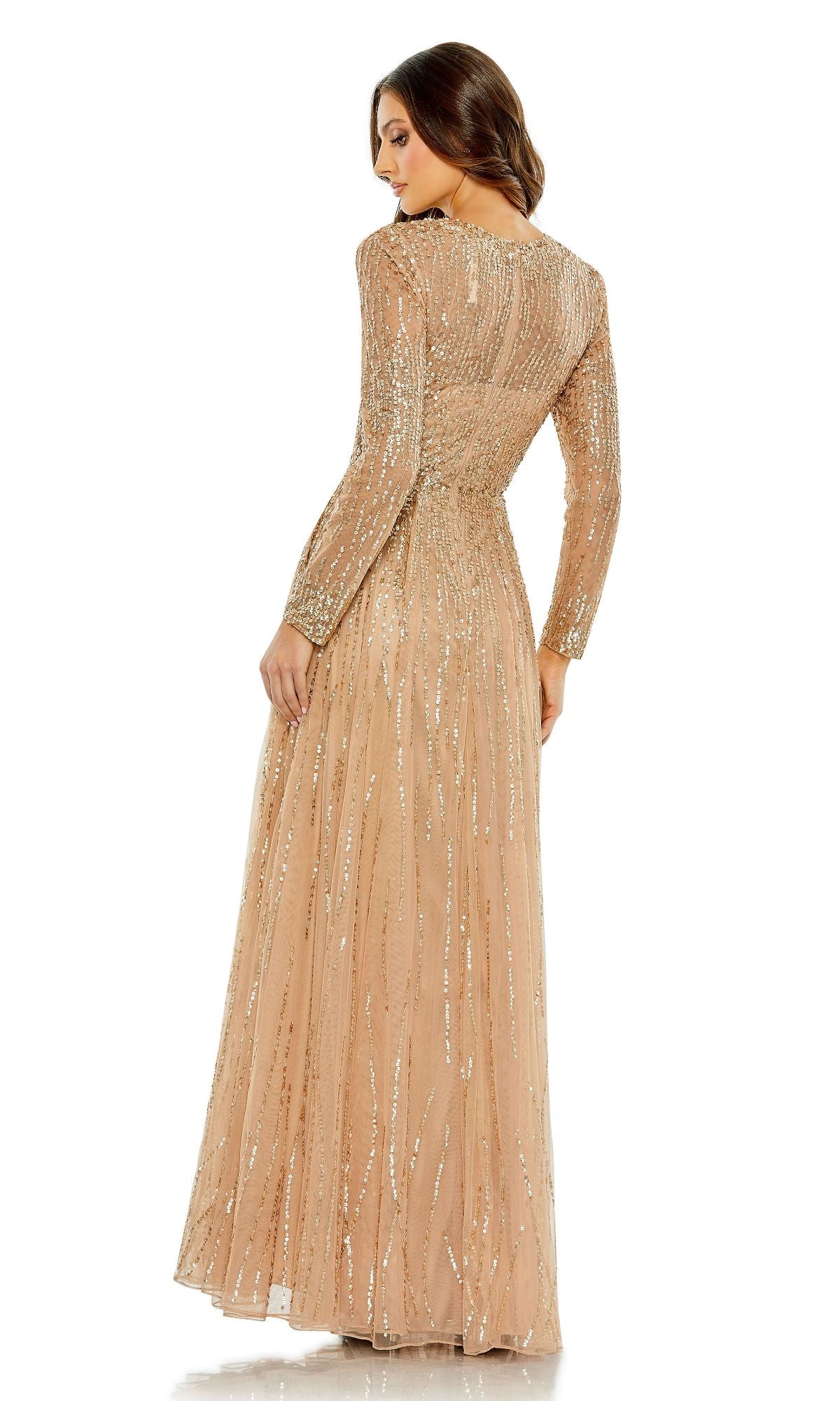 A woman stands facing away from the camera, wearing the Modest Long Sleeve Formal Dress: Mac Duggal 5636, a nude-hued evening gown embellished with sequins.